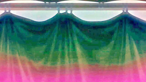 Vibrant gradient curtain in green teal and pink folds with no visible action or nudity