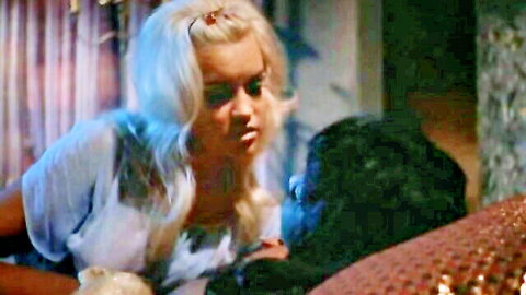Vintage 1970s blonde in sheer top embracing gorilla suit in softcore Cleopatra scene