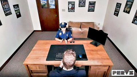 Sexy female police officer in uniform at desk with suited man in roleplay scene