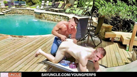 Hunky muscular guard dominating naked redhead twink by pool