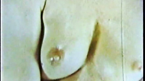 Vintage close-up of pale breasts in Blue Vanities old porn movie
