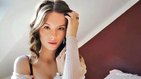 Liz Ocean seductive pose in sheer off-shoulder top, wavy brunette hair