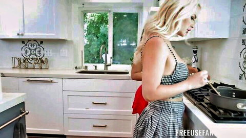 Blonde woman in sexy checkered dress cooking in kitchen, solo tease