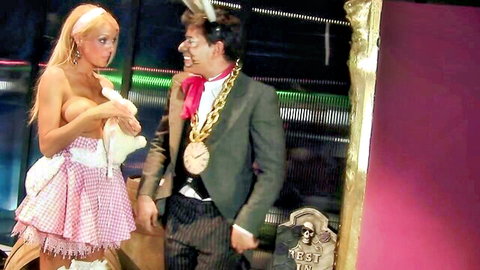 Blonde in sexy checkered dress with Mad Hatter at love party