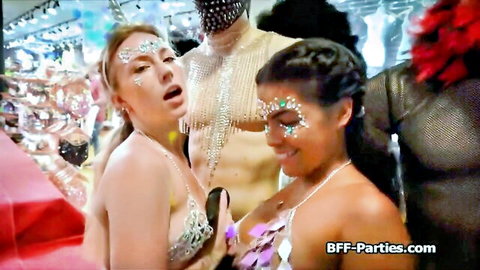 Glitter-faced bikini babes dancing seductively with muscular guys at wild BFF party