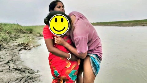 Rani and beau embrace passionately outdoors in Indian sari and lungi by river