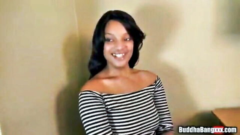 Smiling ebony woman in off-shoulder striped top showing cleavage