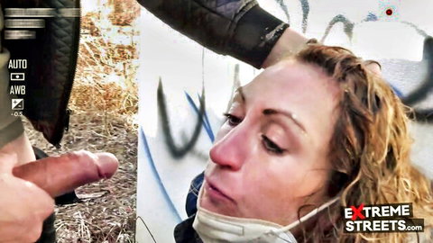 Masked brunette giving outdoor blowjob against graffiti wall