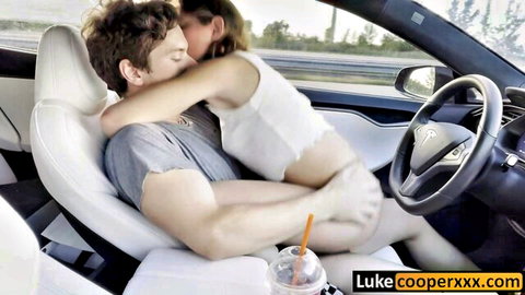 Skinny brunette babe with small tits straddles guy kissing passionately with bare ass exposed in Tesla car on highway
