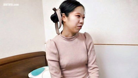 Young mature Asian woman in pink sweater with surprised expression, JAV thumbnail