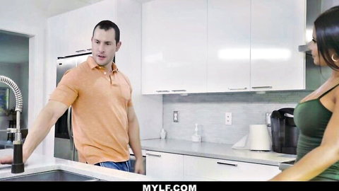 Mature brunette in green top teases muscular man in kitchen, fulfilling her deal