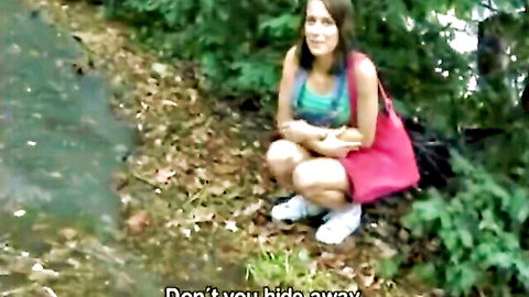 Renata kneeling outdoors in pink skirt and green top, Czech Streets amateur scene