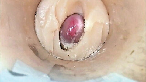 Close-up internal view of tight pink pussy with creamy cum explosion
