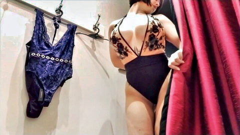 Larkin Love in sexy black lace swimsuit in changing room, model profile view