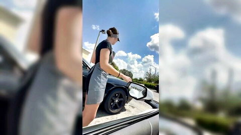 Blonde in short skirt teasing over car hood outdoors