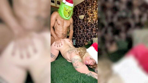 Grinch-masked muscular guy fucks tattooed big ass blonde in missionary, Santa hats