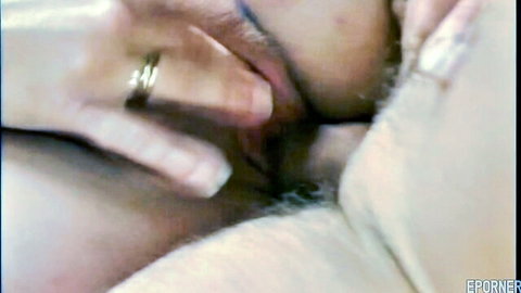 Woman's hand with wedding ring fingering hairy wet pussy closeup