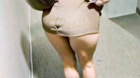 Curvy woman in short checkered dress walking from behind, teasing with her thick thighs and ass