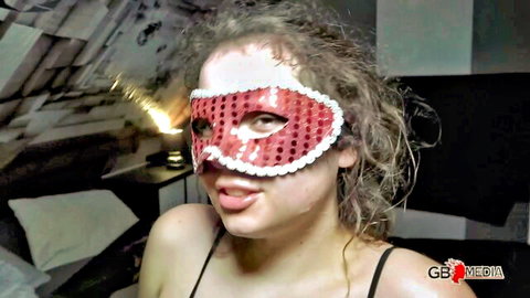 Masked amateur babe with frizzy hair teases by sticking tongue out for cock sucking