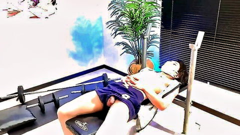 Masked Japanese teen lies on gym bench with hard cock and balls exposed from shorts
