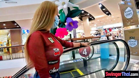 Blonde Thai amateur with huge tits in red cherry top, escalator tease