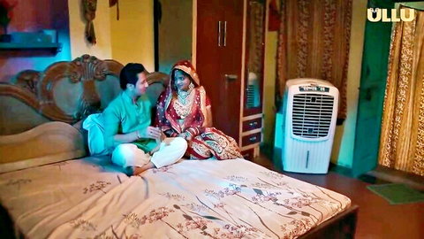 Indian gorgeous MILF in red bridal saree with man on bed, erotic couple scene