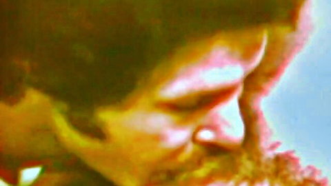 Vintage closeup of bearded man's intense profile face in retro green tint