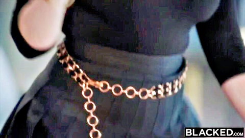 Redhead Annabel Redd teases in black top, skirt and chain belt