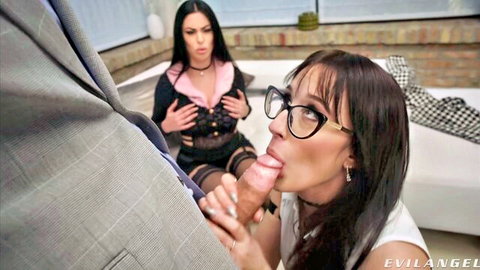 Brunette in glasses sucks thick big cock while lingerie-clad brunette watches eagerly