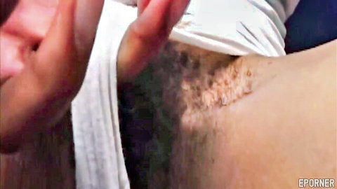 Afro American hairy MILF exposing bushy pubic area close-up