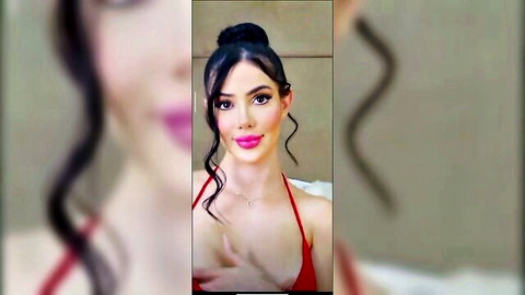 Seductive brunette coquette in red spaghetti strap top teasing cleavage