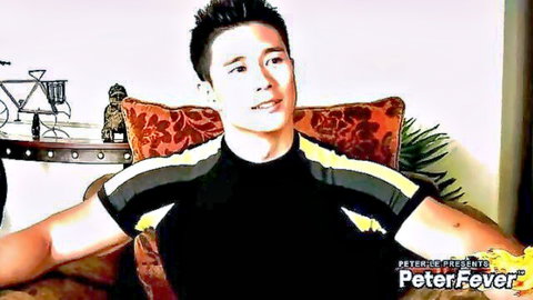 Muscular Asian athlete in sporty shirt posing seductively solo