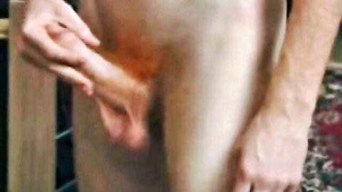 Close-up of hand stroking erect penis in group gay sex scene with four curious boys