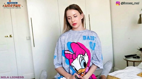 Mila Lioness as young stepmom in Daisy Duck t-shirt, teasing pose on bed