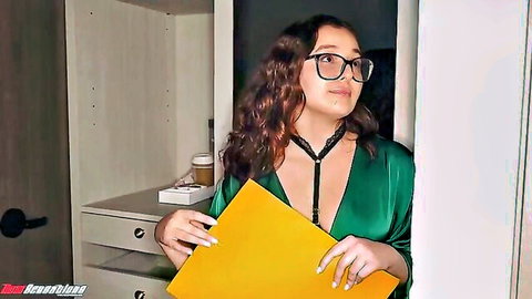 Nerdy hotel manager in sexy green dress and glasses holding folder