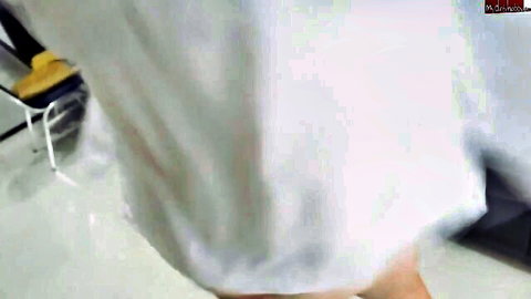 Seductive vixen in flowing white dress, teasing bend pose