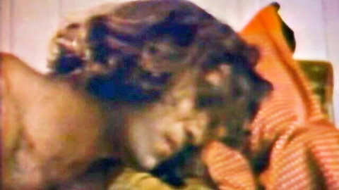 Brunette woman with wavy hair moans in ecstasy during vintage sensual sex