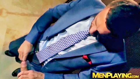 Suited hunk handles gloryhole cock in gay office scene