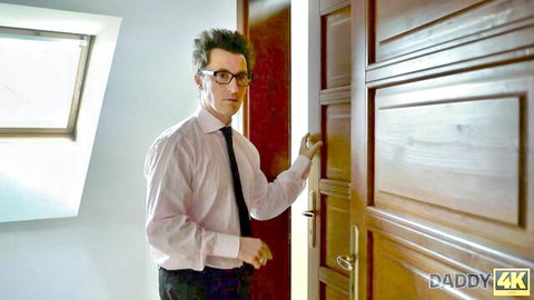 Mature DILF in pink shirt and black tie opens bedroom door in Daddy4K scene