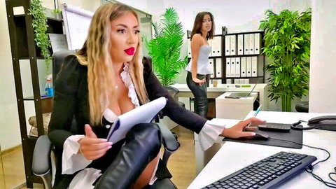 Blonde office babe with massive tits spilling from open blazer and leather pants at desk