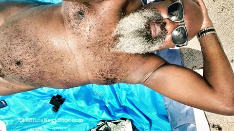 Vicki Verona beach date: shirtless mature black man with beard lounging on sandy towel