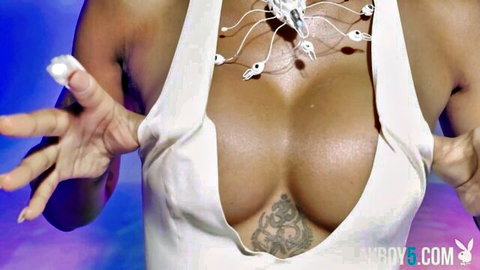 SaBrea Phenix poses in low-cut white dress flaunting cleavage and curves in Playboy softcore