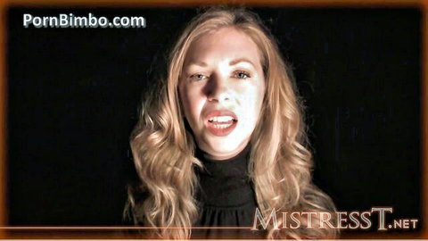 Mistress Tatjana blonde domme in black turtleneck, hypnotic command pose