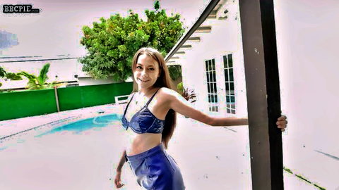 Selena Love in blue bikini posing by pool with teasing smile