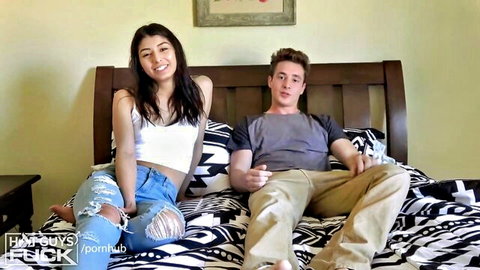 Hot Latina in white tank top and ripped jeans with handsome guy on bed