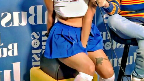 Latina hottie in sexy blue skirt and crop top holding mic