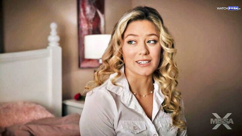Petite blonde teen smiling seductively on pink bed in sheer white blouse