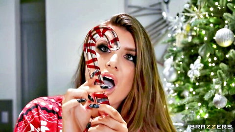 Romi Rain teases with giant candy cane in sexy Christmas sweater