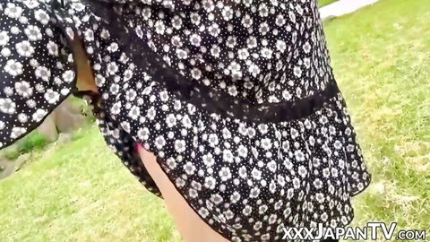 Hot Japanese woman in floral dress and stockings flashing in park