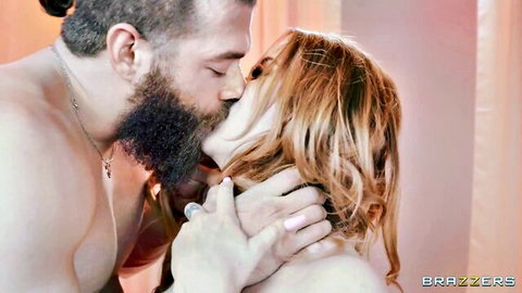 Bearded muscular hunk passionately kisses and grabs redhead beauty's throat in bedroom lingerie tease